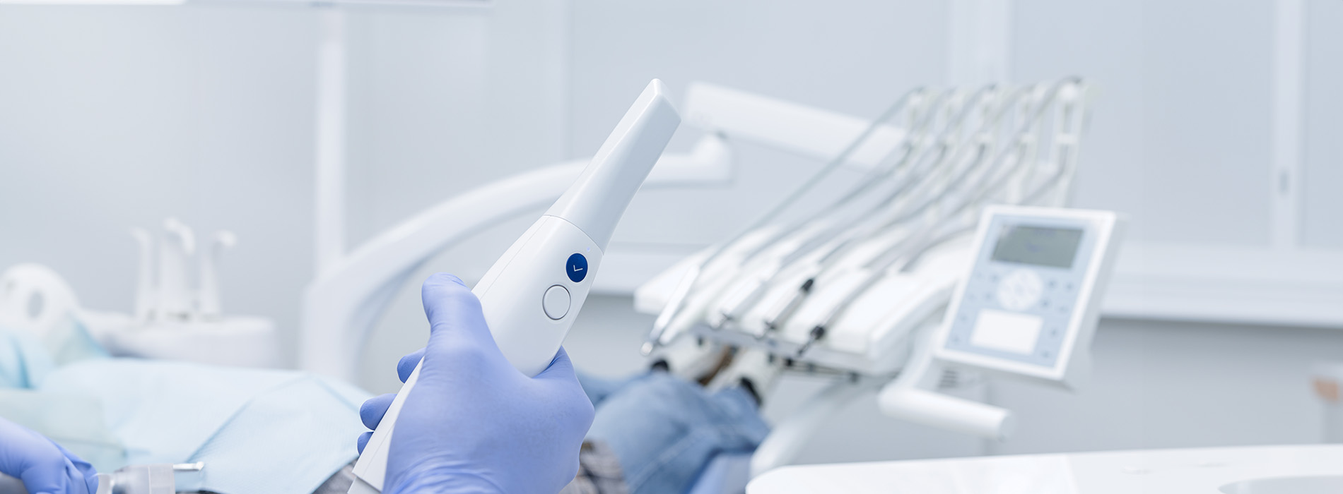 A medical professional operating advanced dental equipment.