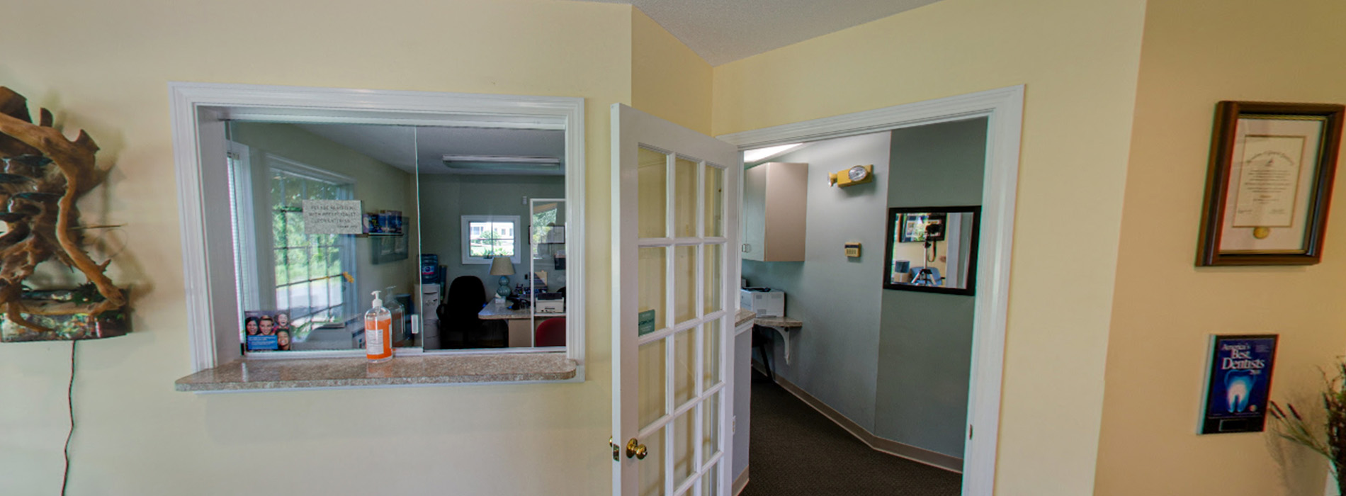 The image shows a modern dental clinic interior with various pieces of equipment, including a dental chair and an X-ray machine.