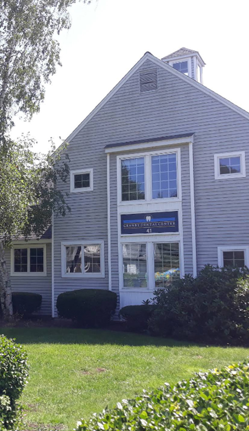 The image shows a modern dental or medical office interior with a dental chair, equipment, and a clean, professional environment.